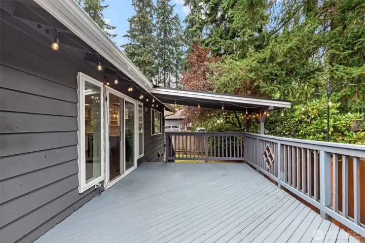 Party-ready covered deck with bistro lights and railing detail.