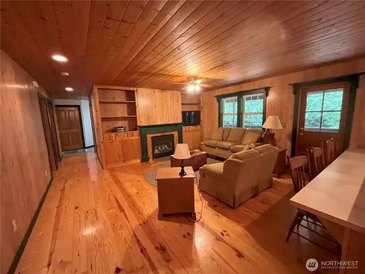 Living room with natural pine flooring.