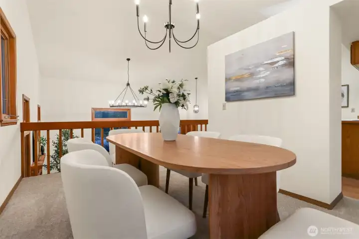 Formal dining room off kitchen overlooking living room taking in front yard and pond views.