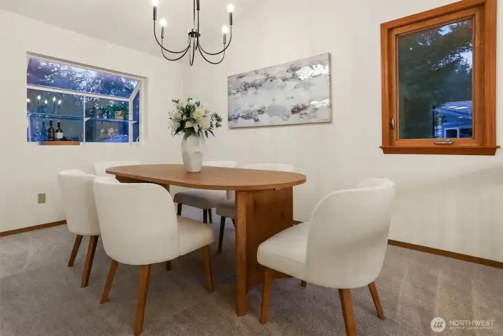 Dining room with designer lighting, and light-filled garden window.