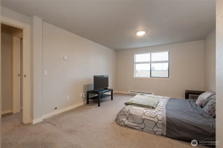 Spacious primary suite with attached half bath and two large closets