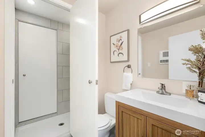 Functional guest bath offers walk in shower that is accessible from primary bathroom.
