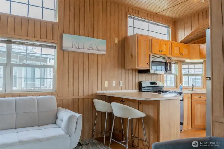 The high windows in the living room and kitchen fill the space with natural light