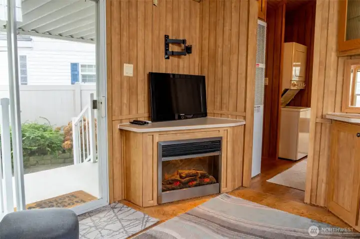 Electric fireplace with wall mount for tv and direct access to porch and patio from the living area