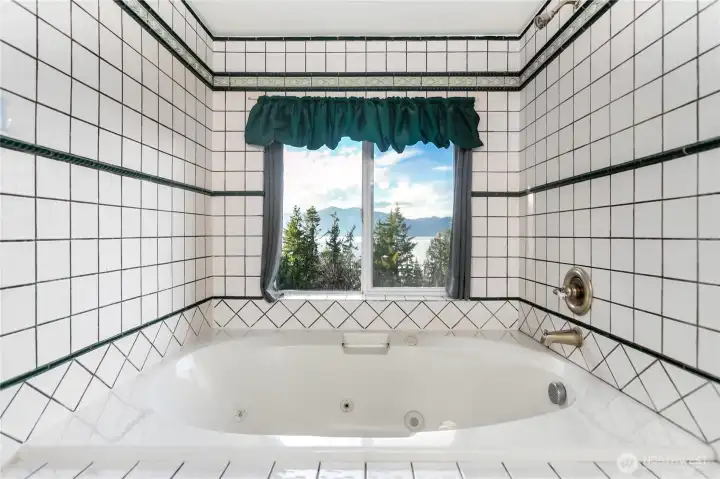 Your own mountain spa retreat awaits! Fully tiled primary bath with a large jetted tub takes in the view for a most relaxing soak. Your own mountain spa retreat awaits! Fully tiled primary bath with a large jetted tub takes in the view for a most relaxing soak.