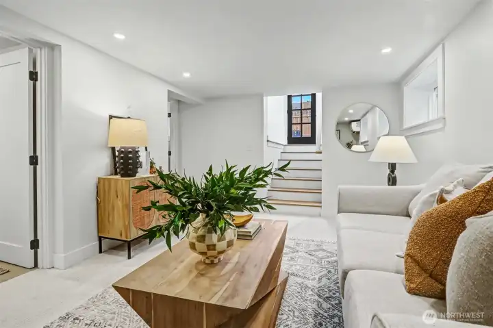 Family room looking towards hardwood stairs and backyard