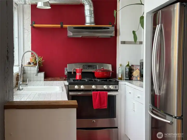 Beautiful galley kitchen with gas range.