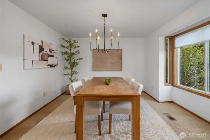 Spacious formal dining room with a bay window.