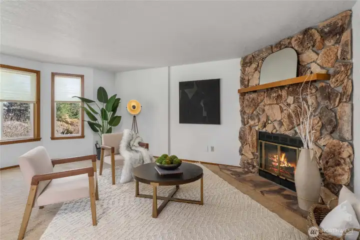 The living room features bay windows.