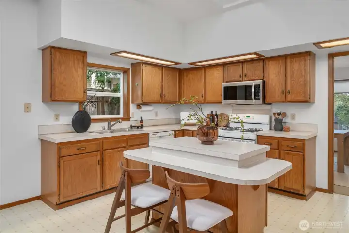 Spacious kitchen with center island, integrated lighting and a skylight.