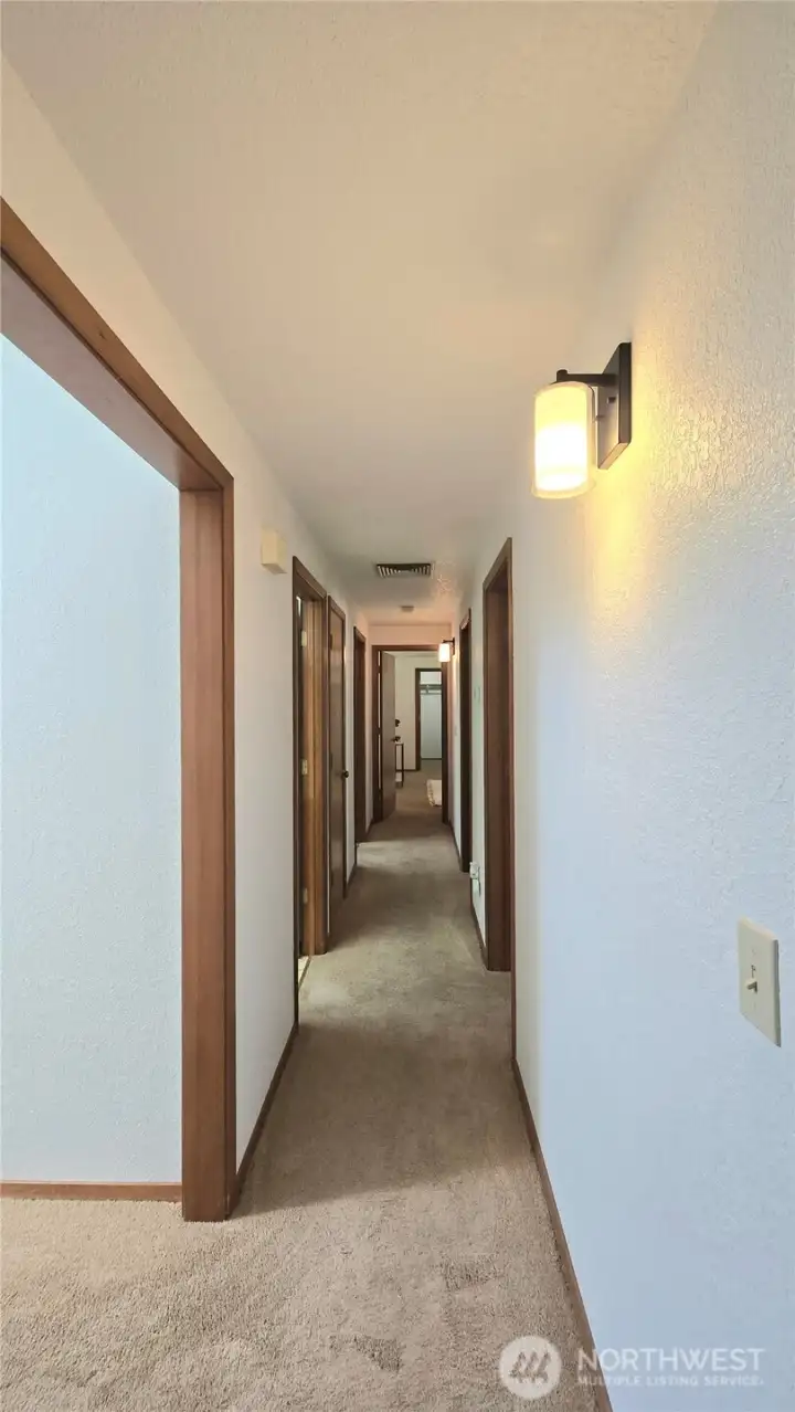 The hallway leads to the bedrooms at the back of the home