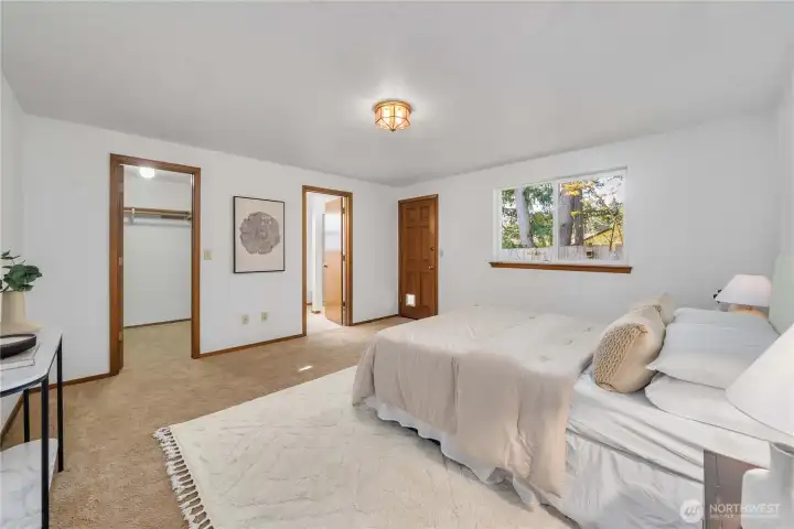 the doors lead to a walk-in closet, the en-suite bathroom, and to the back yard.