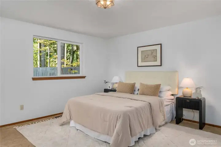 Enjoy serene views of the peaceful and wooded back yard