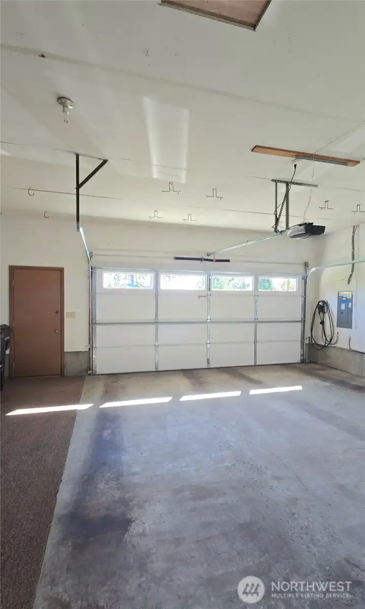 The large, extra-deep garage offers a service door, plenty of shelves for storage and an included chest freezer.