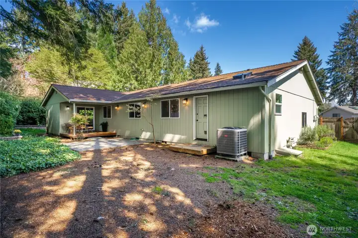 The fenced back yard backs to the wooded community greenbelt.