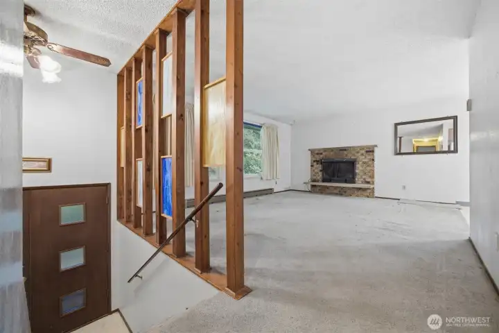 Upstairs there is a spacious living room which is open to the dining area. There is a wood burning fireplace.