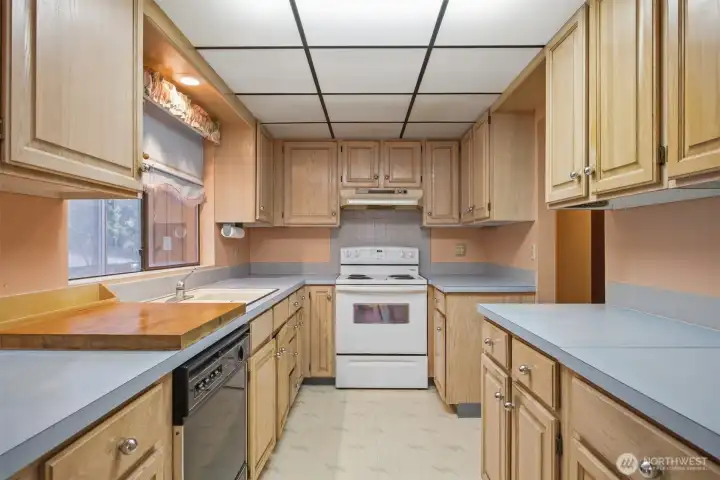 The kitchen has a good work triangle and an abundance of cabinets and counter space.