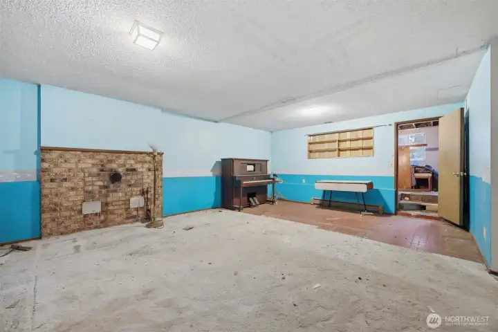 Looking across the family room toward the area that had a wood stove. The floor is brick toward the rear entry area.