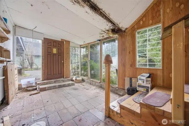 Looking at the back entry which was enclosed and possibly not permitted.