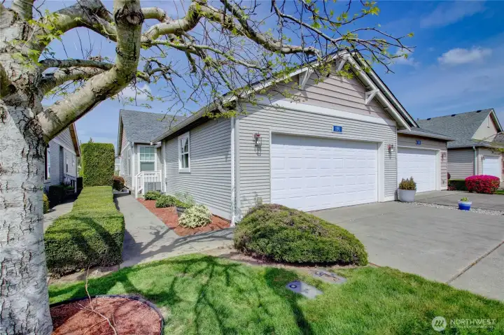 Welcoming pathway leads to covered front entry with charming curb appeal and mature landscaping.