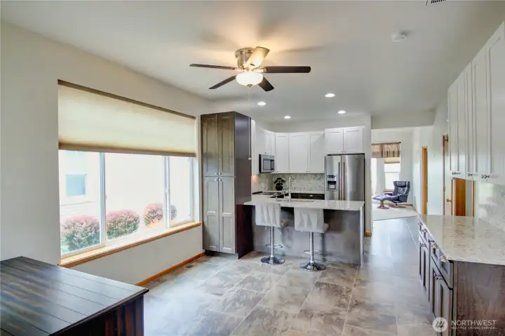 Open dining area with easy flow to the kitchen and breakfast bar for comfortable dining and gathering space.