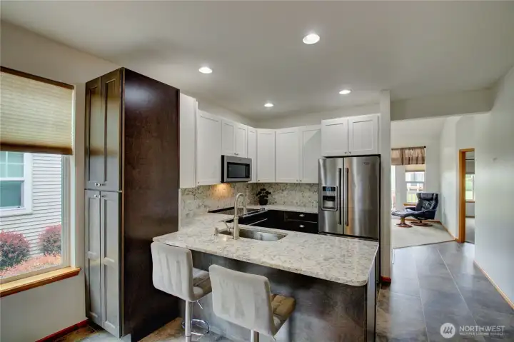 Exceptional countertop workspace and cabinet storage throughout.