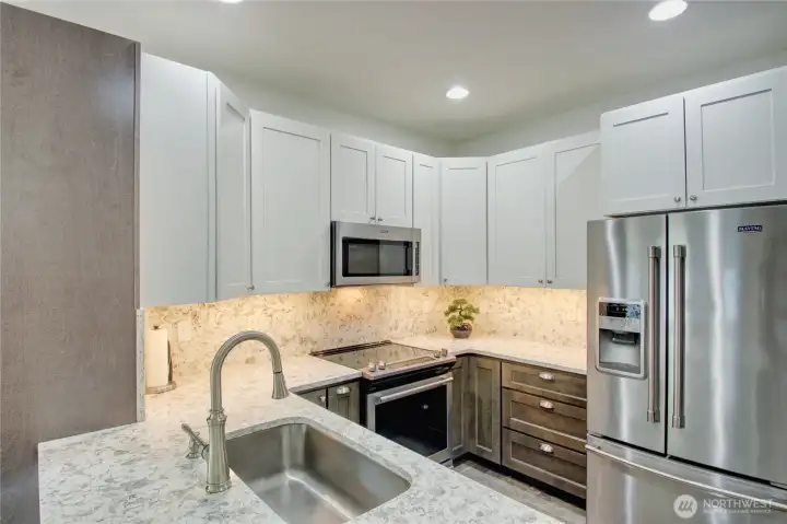 Soft under-cabinet lighting provides both warmth and added task lighting to the kitchen workspace.
