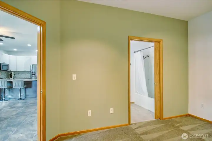 Secondary bedroom located near front door and connected to second bathroom for added flexibility.