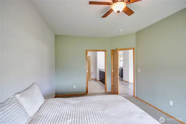 Spacious primary suite with adjacent updated bath and large walk-in closet.