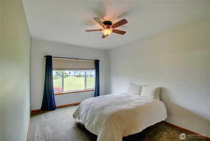 Primary suite overlooks greenbelt.