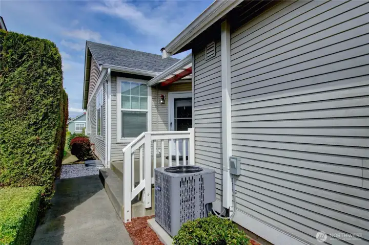 Nicely landscaped walkway leads to welcoming front porch.