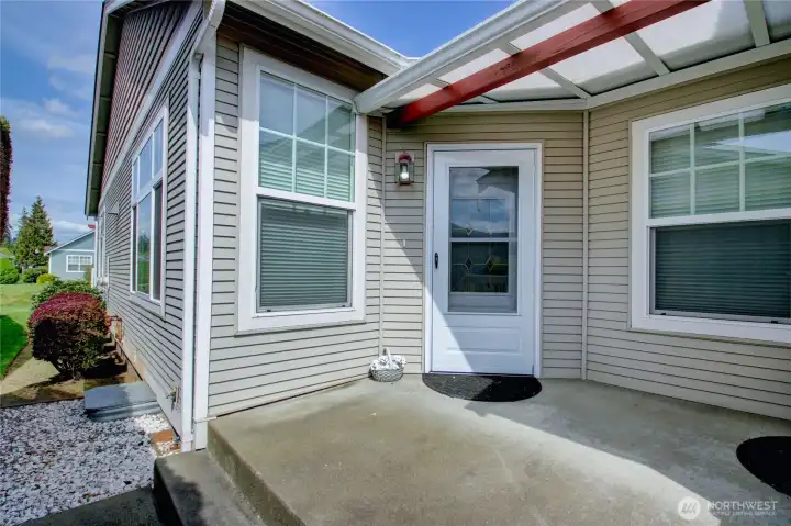 Private front entry offers access to both front door and attached garage door.