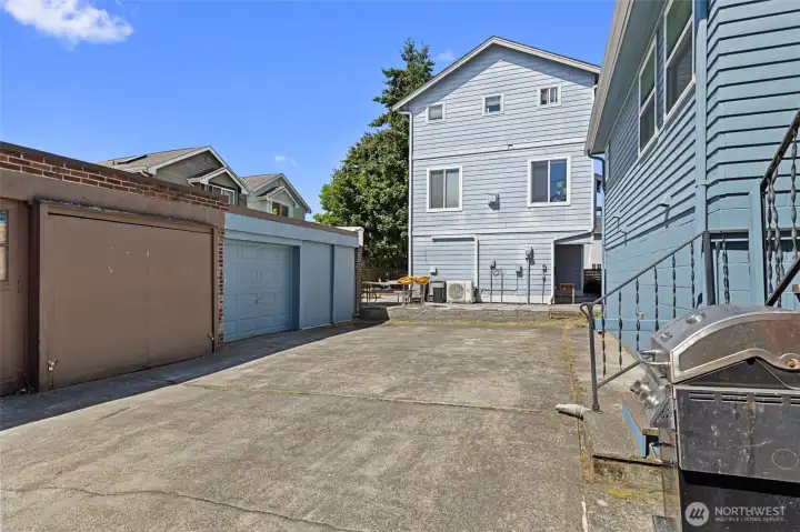 Blue garage belongs to this property. Room for one car plus LOTS of storage. Also space for 2 parked cars on concrete.