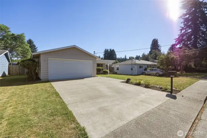 Inviting front entry with attached two-car garage.