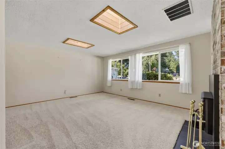 Natural light pours in through skylights and a large picture window.