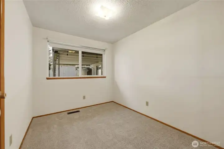 Comfortable secondary bedroom overlooking the backyard and new carpets