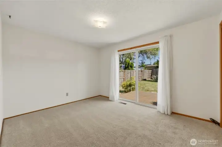 Spacious primary bedroom with private backyard access.