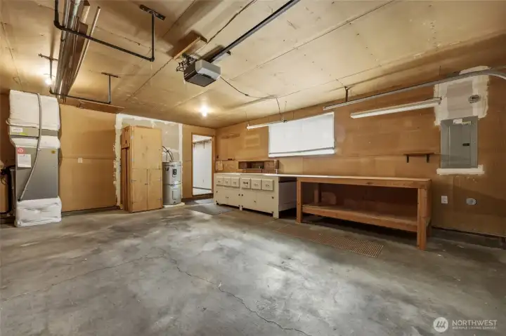 Attached two-car garage features built-in workbench and storage.