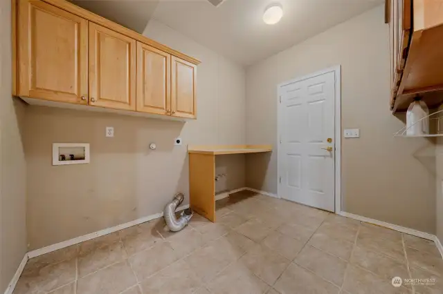 Huge laundry room with cabinets and counter so convenient for folding laundry.