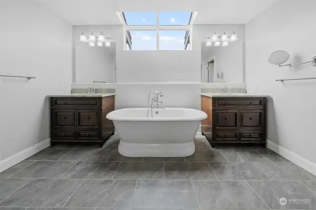 5-piece bath with contemporary ceramic flooring, standalone tub and granite counters.