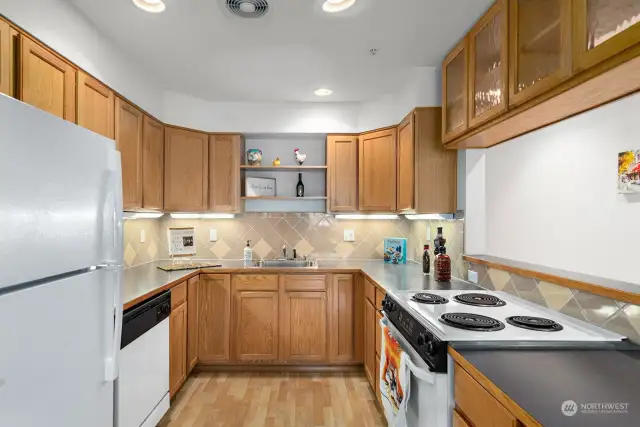 U-shaped Kitchen is quite large!   Plenty of wood cabinetry and tons of counterspace make this kitchen a wonderful place to prepare meals.