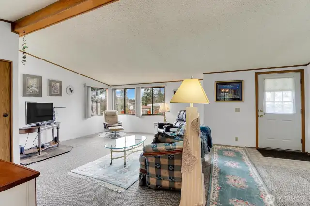 Living Room with Vaulted Ceiling & Corner Windows for an abundance of natural light!