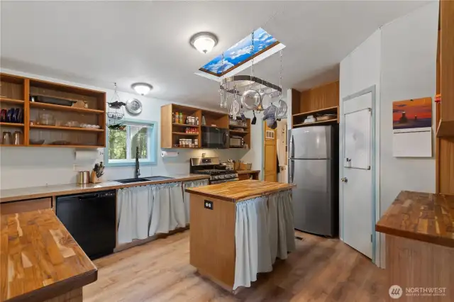 Spacious kitchen with vaulted ceilings and skylight