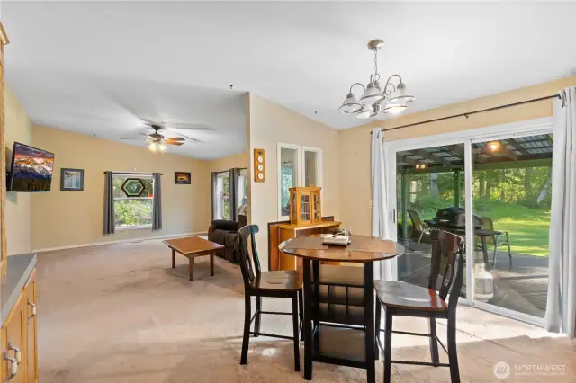 Dining area off of the kitchen lead to a den, and provides access to the back of this beautiful property