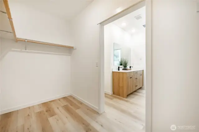 Spacious primary closet. Photos shown are of a similar floor plan previously built in a different neighborhood (The Ridge in Blaine). Finishes and features may vary. Some items pictured reflect buyer-selected upgrades which are not included in the base price and may be added at an additional cost.