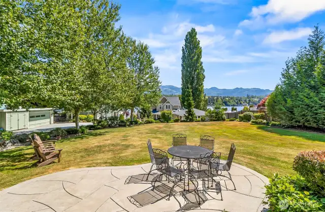 cottage patio overlooking mature landscaping down to the lake