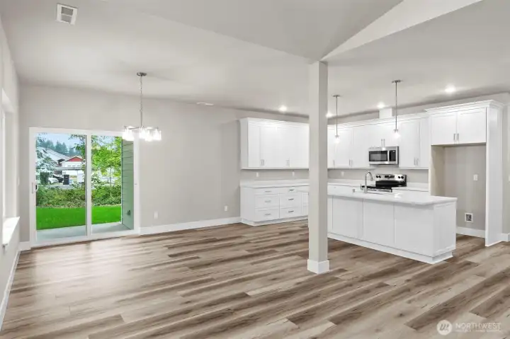 Slider leads out to oversized back patio, as well as the access to the 3 car garage!