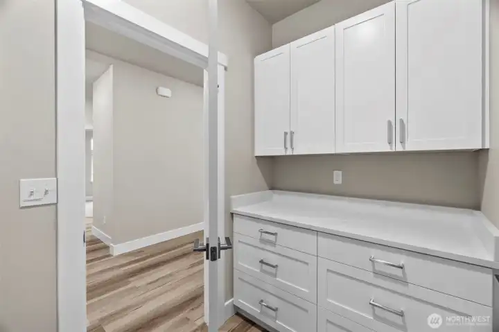 Utility/Mudroom with plenty of counter space for folding laundry, and ample storage!
