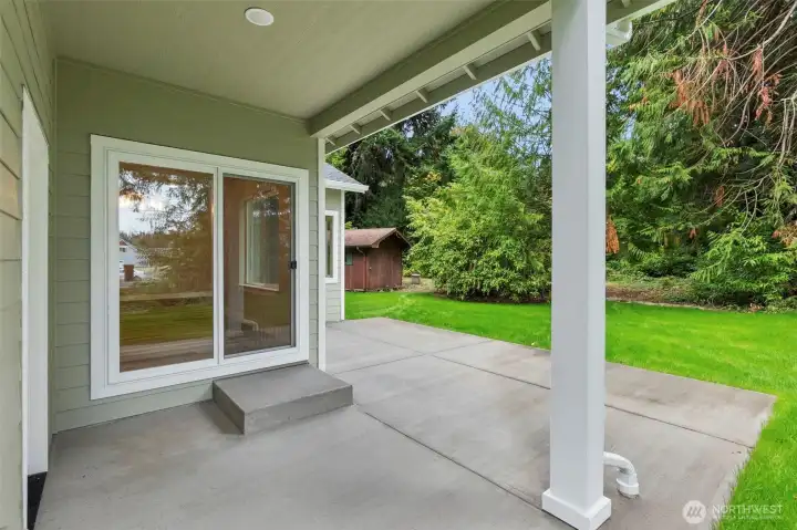 Oversized back patio, with covered area for grilling, relaxing, or morning coffee.