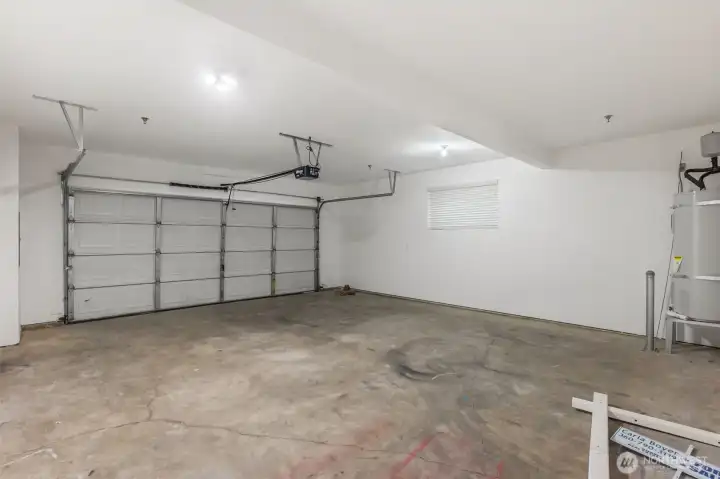 A two car garage with a condo?  Yes indeed.  It's all sheet rocked and finished too.  Walk right from your car directly into the entry room!  "Honey, I'm home."